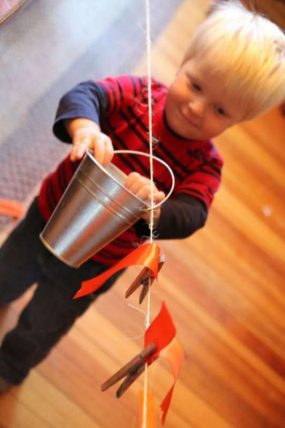 A simple clothesline and bucket activity for toddlers