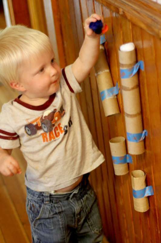 Recycled Tubes. Save paper towel and toilet paper tubes to hang on a wall as something to drop objects through like the pom pom drop. It'll amaze them and keep them busy!