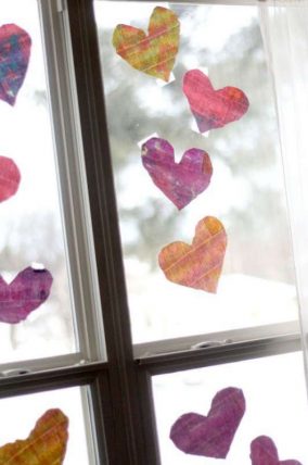 Painting watercolor hearts to hang on the window for Valentine's Day